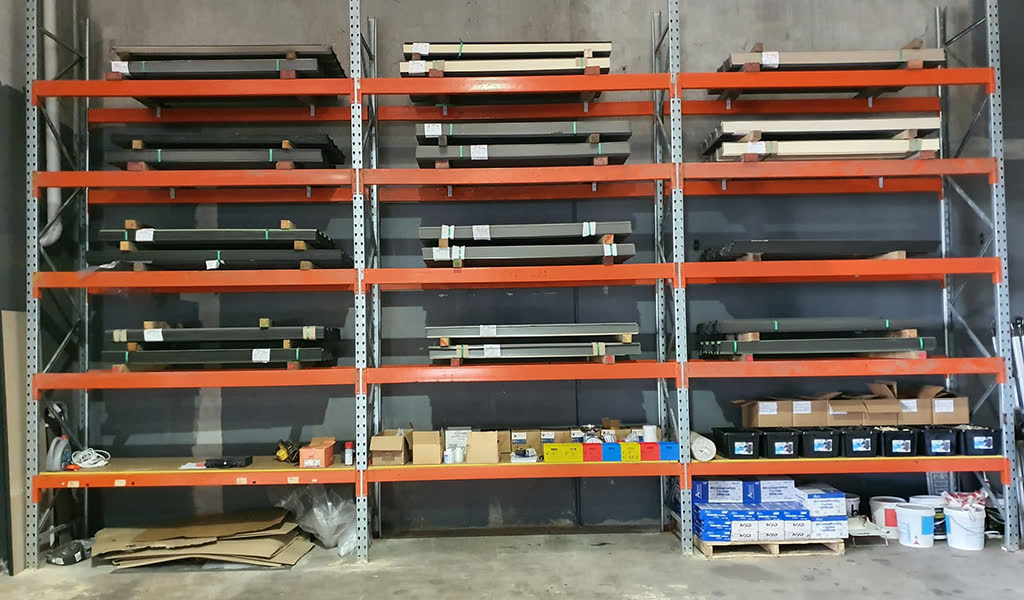 Pallet racking with steel sheets, boxes and paint buckets